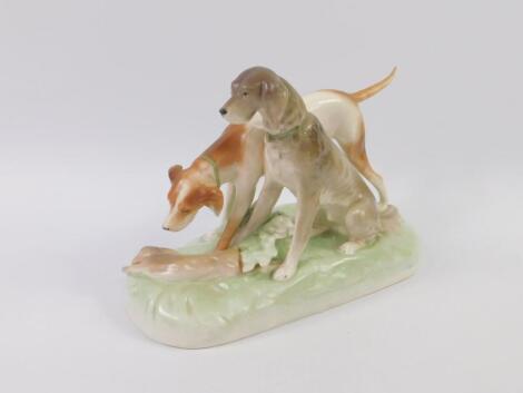 A Royal Dux type porcelain figure group modelled as two hounds with a dead hare