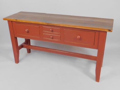 A pine dresser base with a red painted casing of two short and two deep drawers