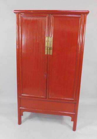 A Chinese red lacquer cupboard