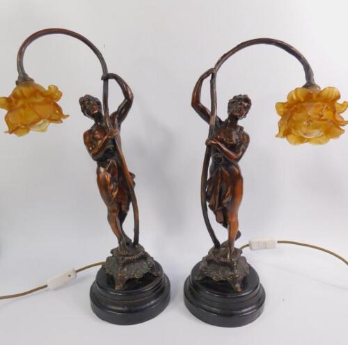 A pair of lacquered spelter figural table lamps