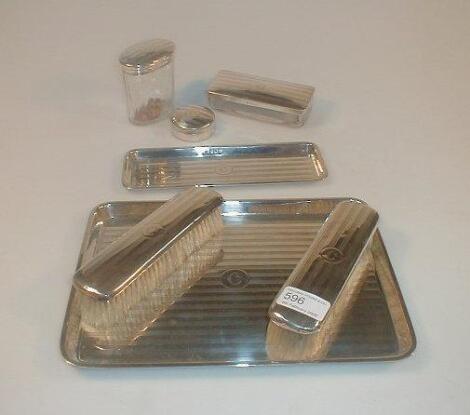 A silver seven piece dressing table set