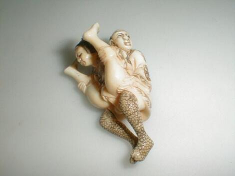 A Japanese ivory erotic netsuke depicting a lovemaking couple