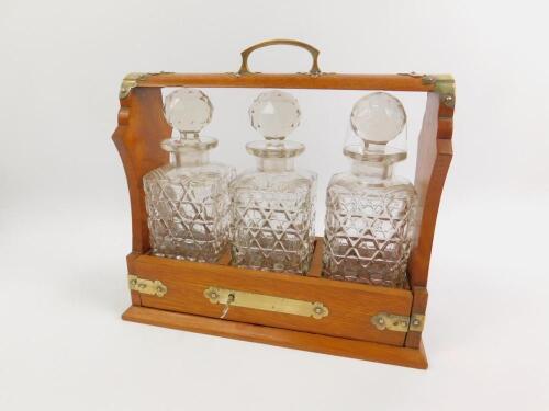 An oak and brass mounted three bottle tantalus