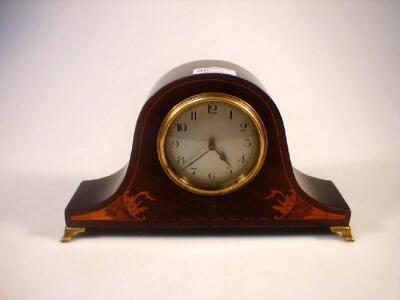 A mahogany marquetry mantel clock on brass oge£ feet