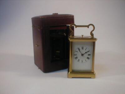 A gilt brass chiming carriage clock together with an associated leather case