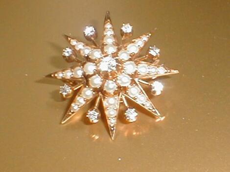 A Victorian diamond and seed pearl set star brooch in yellow metal