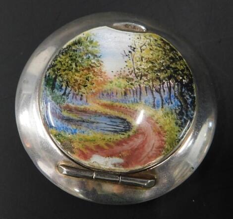 A silver and enamel circular pill box