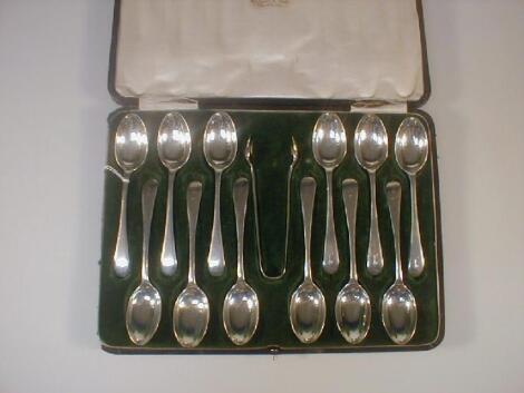 A George V set of twelve silver Old English pattern teaspoons and a pair