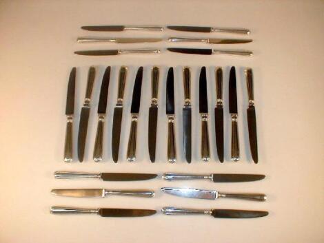 A set of twelve silver handled table knives and matching dessert knives