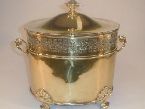 A brass coal box and cover of oval form