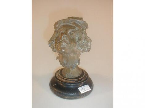 A Bronze mask on a turned ebonised socle stamped HARPO MARX 1929