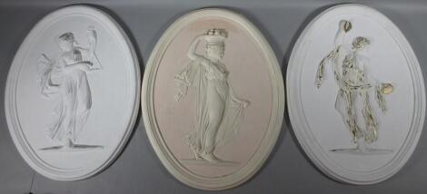 A matched pair of reproduction plaster style oval wall plaques