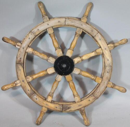 A rustic lightwood ship's wheel