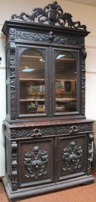 A heavily carved 19thC Continental oak bookcase