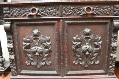 A heavily carved 19thC Continental oak bookcase - 2