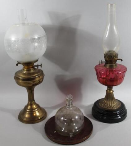 An early 20thC cranberry and clear glass oil lamp