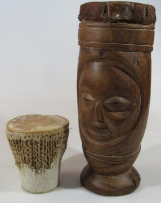 A 20thC hide topped carved wooden African tribal drum
