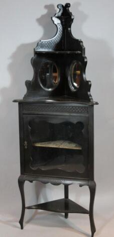 A late Victorian ebonised corner cabinet