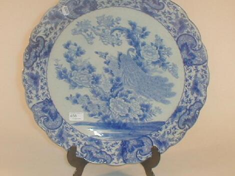 A Japanese blue and white charger decorated with a peacock in underglaze blue