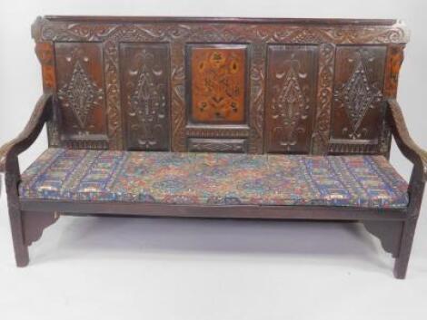 An 18thC oak and marquetry inlaid settle