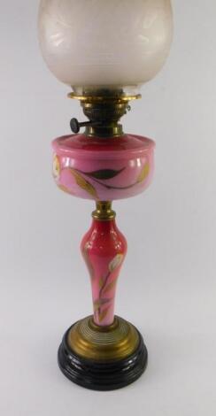 A Victorian brass and red opaline glass oil lamp