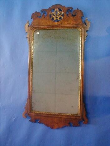 A mid 18th century walnut framed wall mirror with fret cut and pierced frame