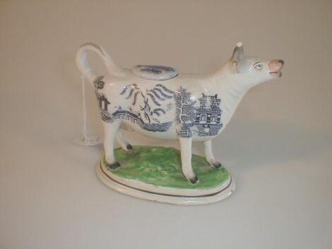 A 19th century Staffordshire blue and white willow pattern cow creamer