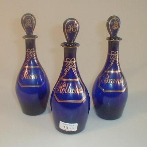 A set of three 19thC Bristol blue mallet shape spirit decanters and stoppers