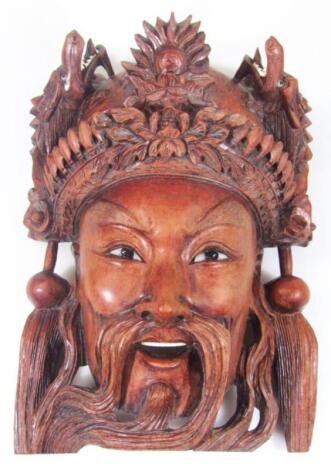 An early 20thC Tibetan carved wooden face mask