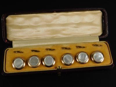 A set of mother of pearl collar studs