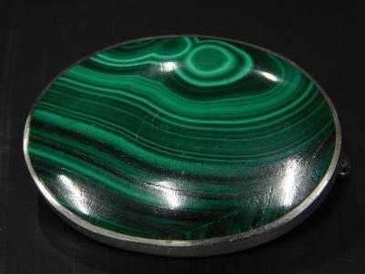 A malachite silver framed brooch