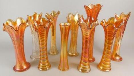 A collection of ten Carnival glass marigold coloured vases