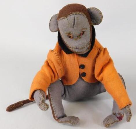 A mid 20thC felt toy monkey