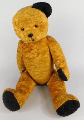 A mid 20thC straw filled bear (AF)