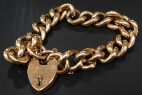 A 9ct gold curb link rose gold bracelet and padlock clasp