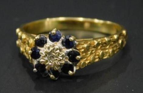 An 18ct gold sapphire and diamond cluster ring