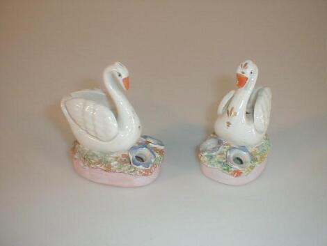 A pair of late Victorian Staffordshire pottery pen holders