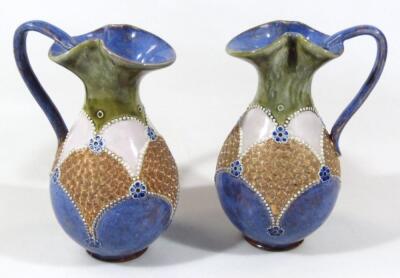 A pair of early 20thC Royal Doulton stoneware ewers