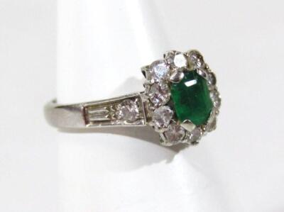 An 18ct white gold emerald and diamond ring