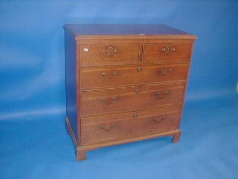 A Georgian oak chest of two short and three long drawers with brass swan