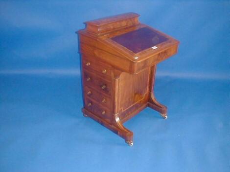 A Victorian figured walnut Davenport with domed and raised letter rack and pen tray