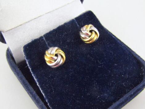 A pair of yellow metal bi-colour knot earrings