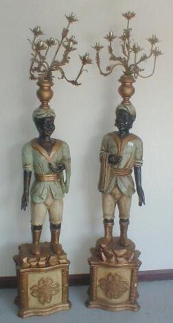 A pair of carved gilt and painted Blackamoor electrolier figures