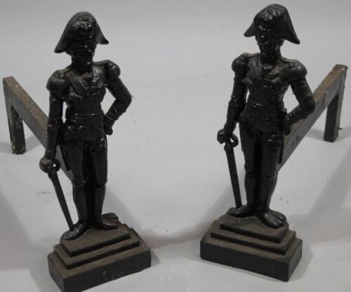 A pair of early 20thC cast iron Napoleonic style fire dogs