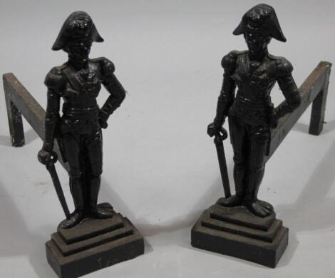 A pair of early 20thC cast iron Napoleonic style fire dogs