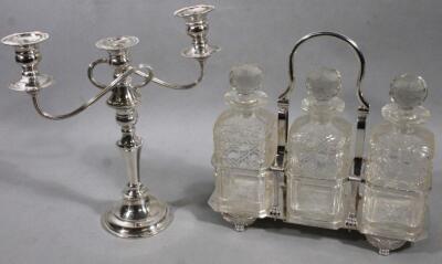 A 20thC silver plated three bottle decanter set