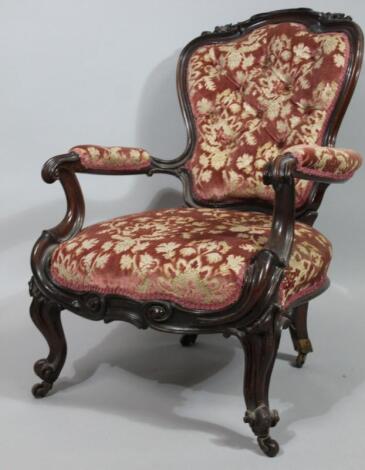 A heavily carved Victorian armchair