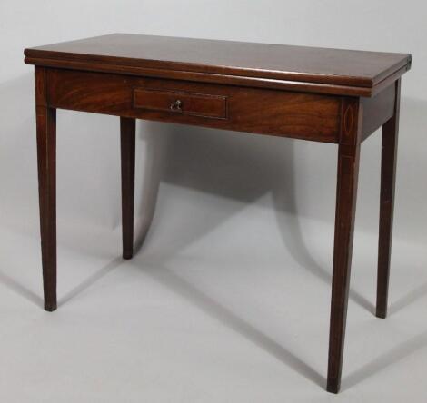 An early 19thC mahogany fold over Sheraton tea table