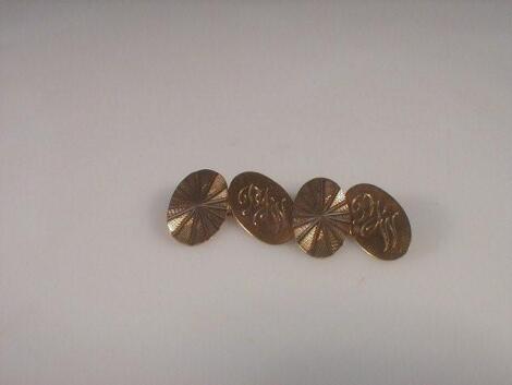 A pair of oval 9ct gold cuff links