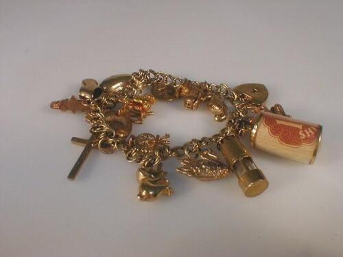 A 9ct gold charm bracelet with fifteen attached charms